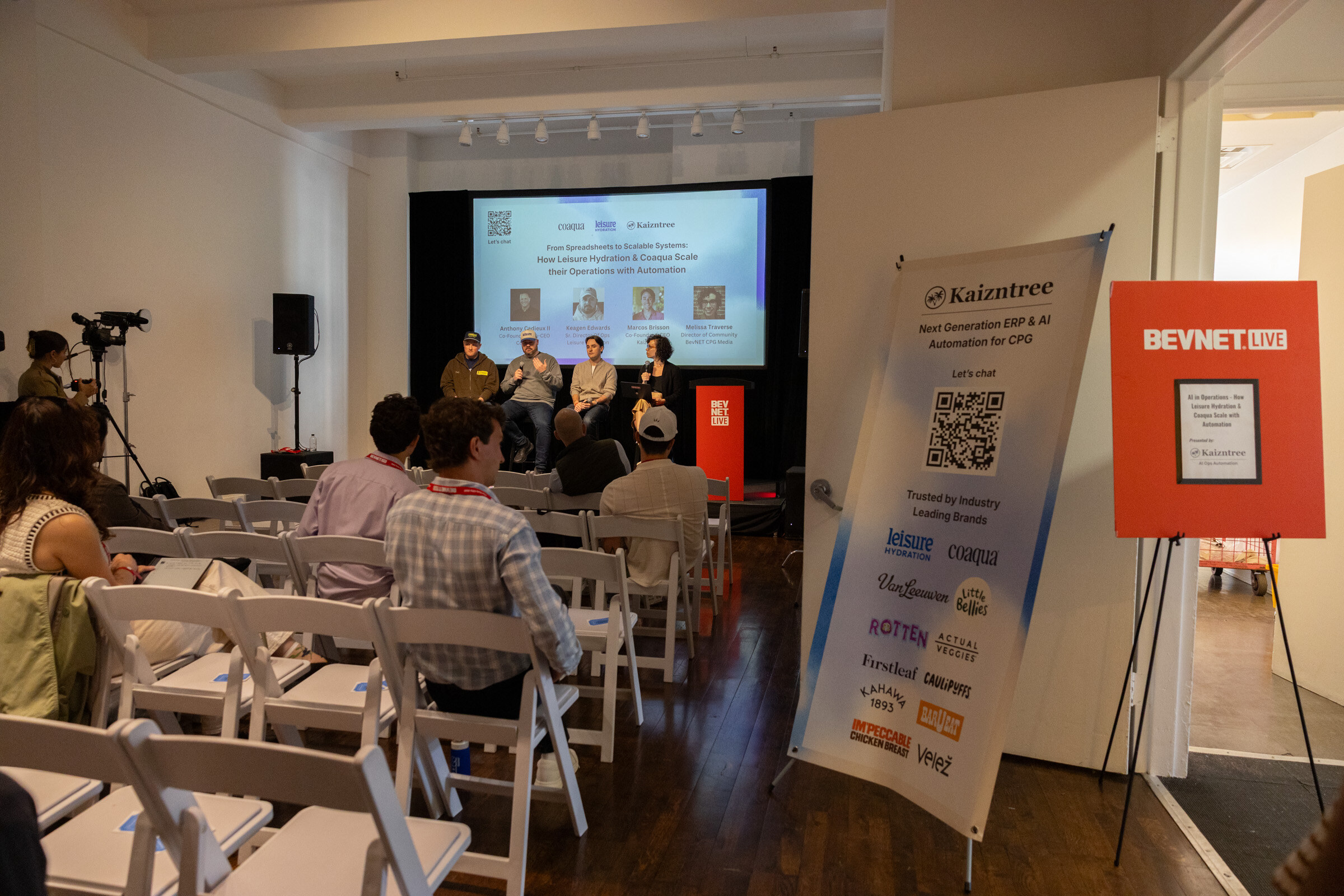 Long room with rows of chairs facing a four-person panel, with a Kaizntree banner and a BevNET Live sign in the foreground.