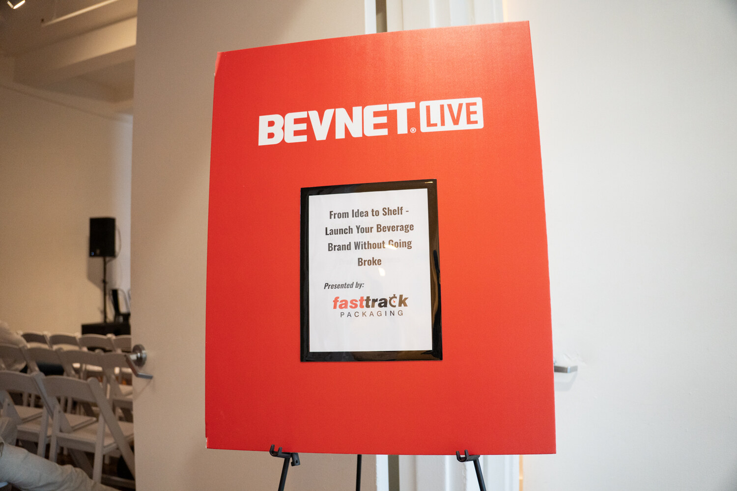 Red BevNET Live easel sign with the Fast Track Packaging workshop title.