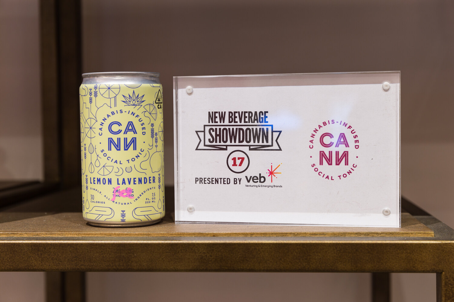 CANN lemon lavender can displayed beside a New Beverage Showdown sign.
