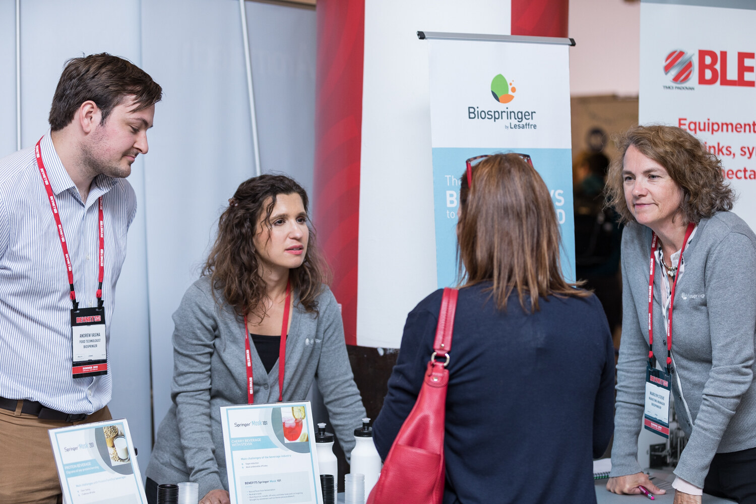 Exhibitors at the Biospringer booth speaking with visitors in front of Biospringer and Blendtech banners.