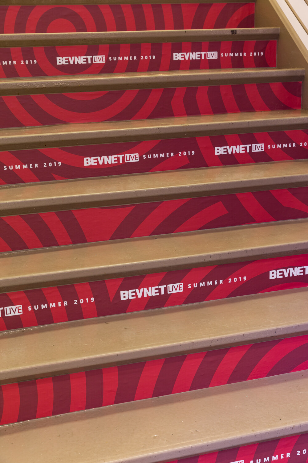 BevNET Live Summer 2019 branding on the risers of a red staircase.