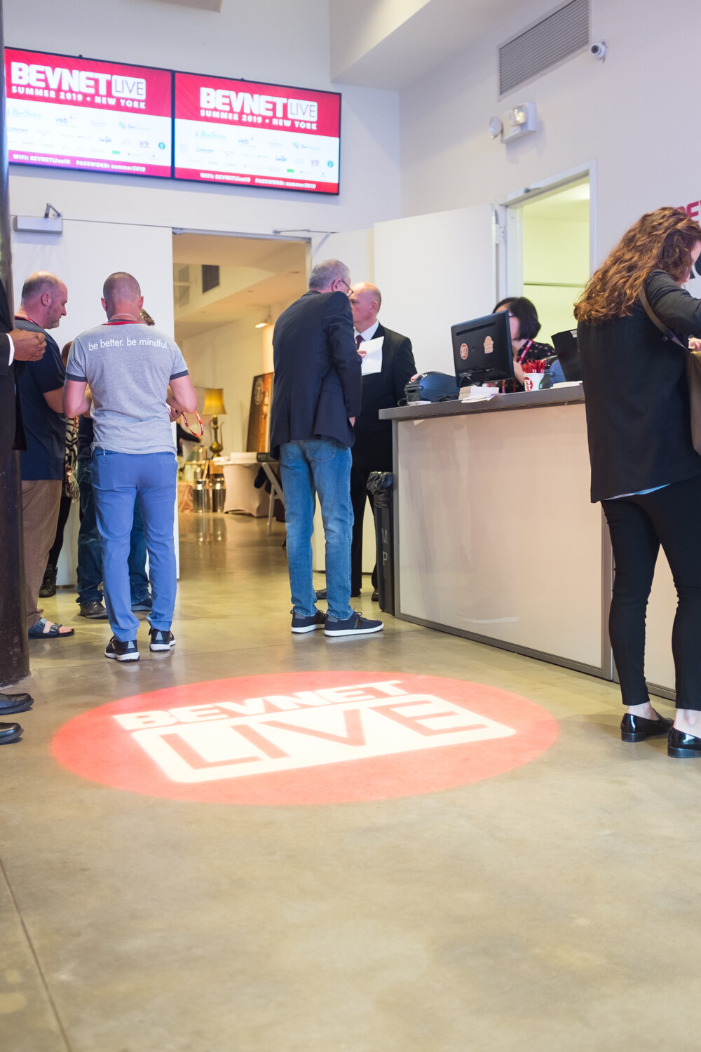 BevNET Live logo projected on the floor near the registration entrance.