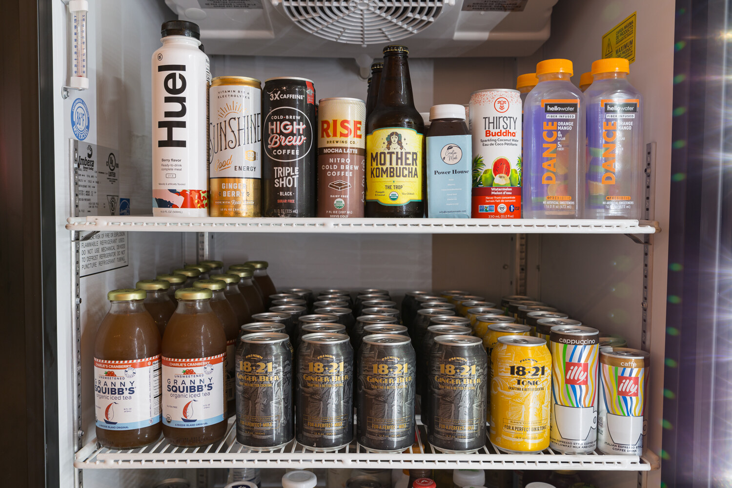 Cooler shelves stocked with Huel, Sunshine, Thirsty Buddha and 18.21 beverages.