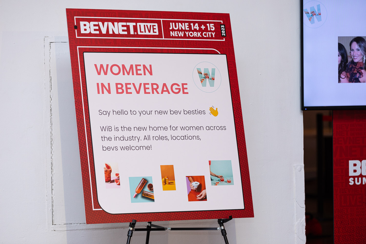 A red easel sign reading BevNET Live June 14 and 15 New York City and Women in Beverage, Say hello to your new bev besties, with a screen at right.