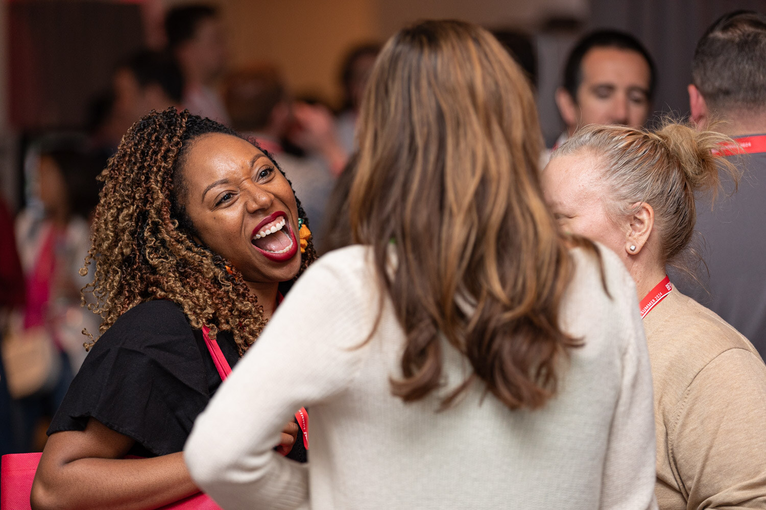 Attendee laughs in a crowd at the BevNET Live happy hour.