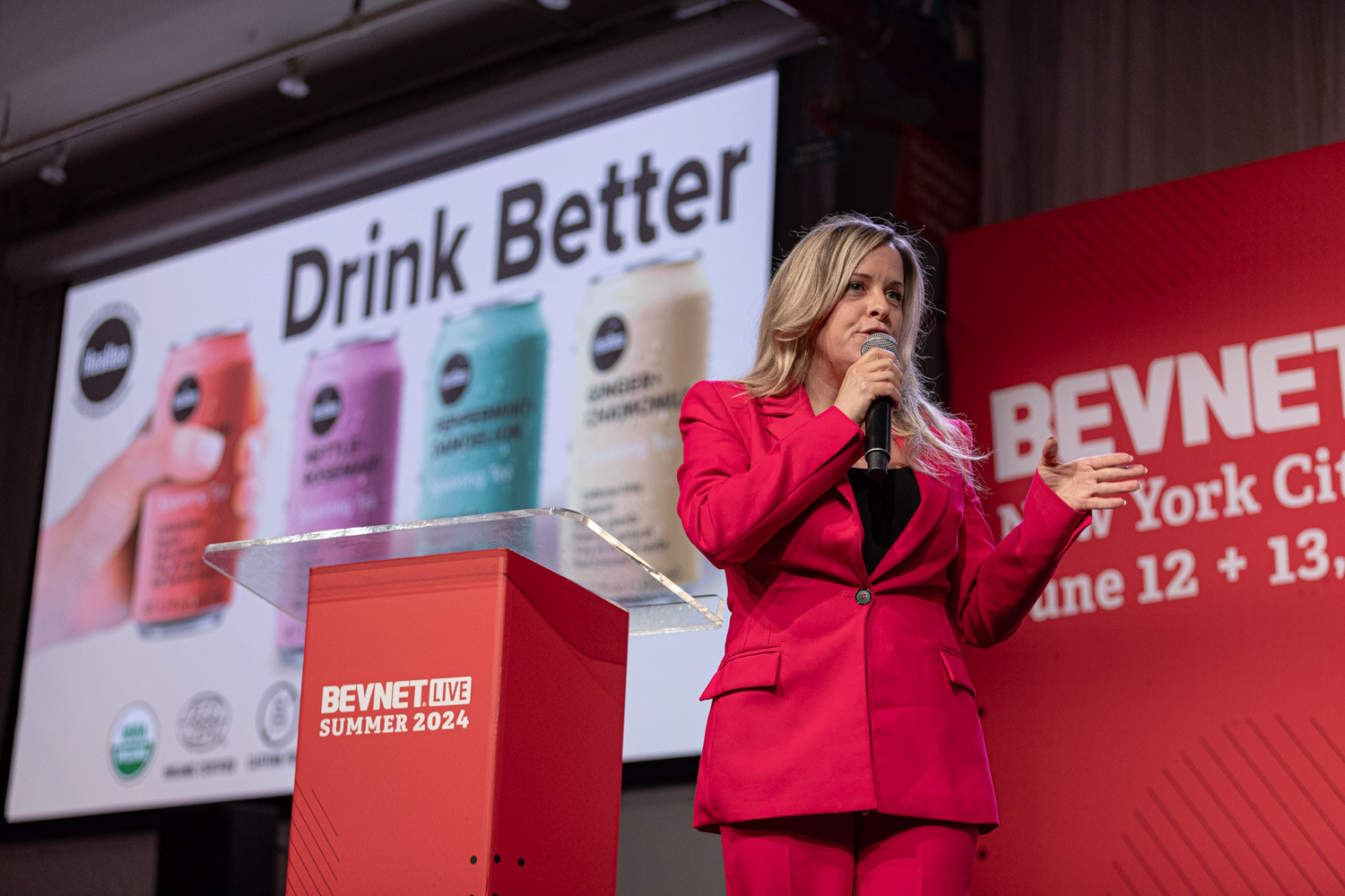 Contestant presents a Drink Better slide showing four canned drinks.