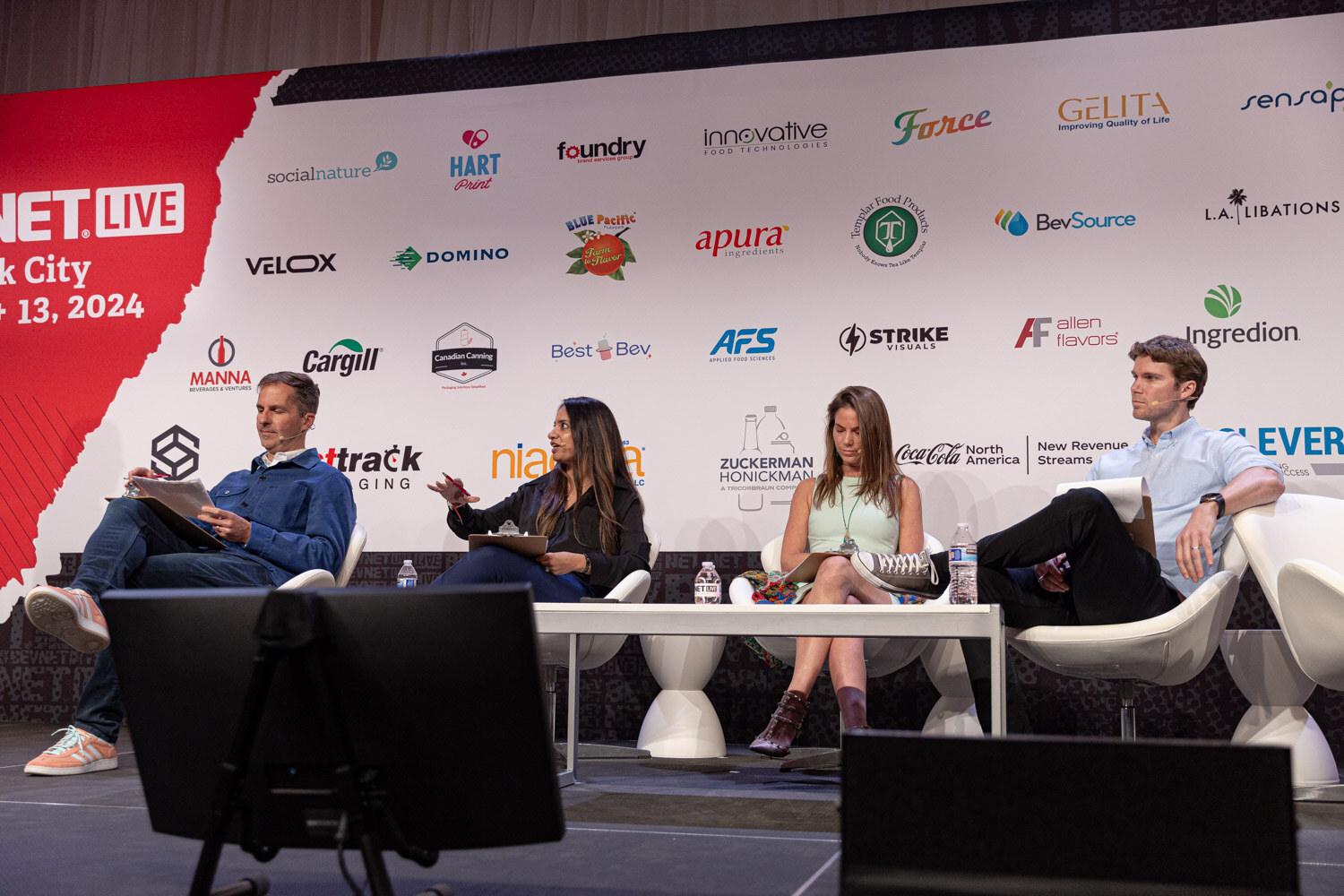 Wide view of the four judges seated on the New Beverage Showdown stage.