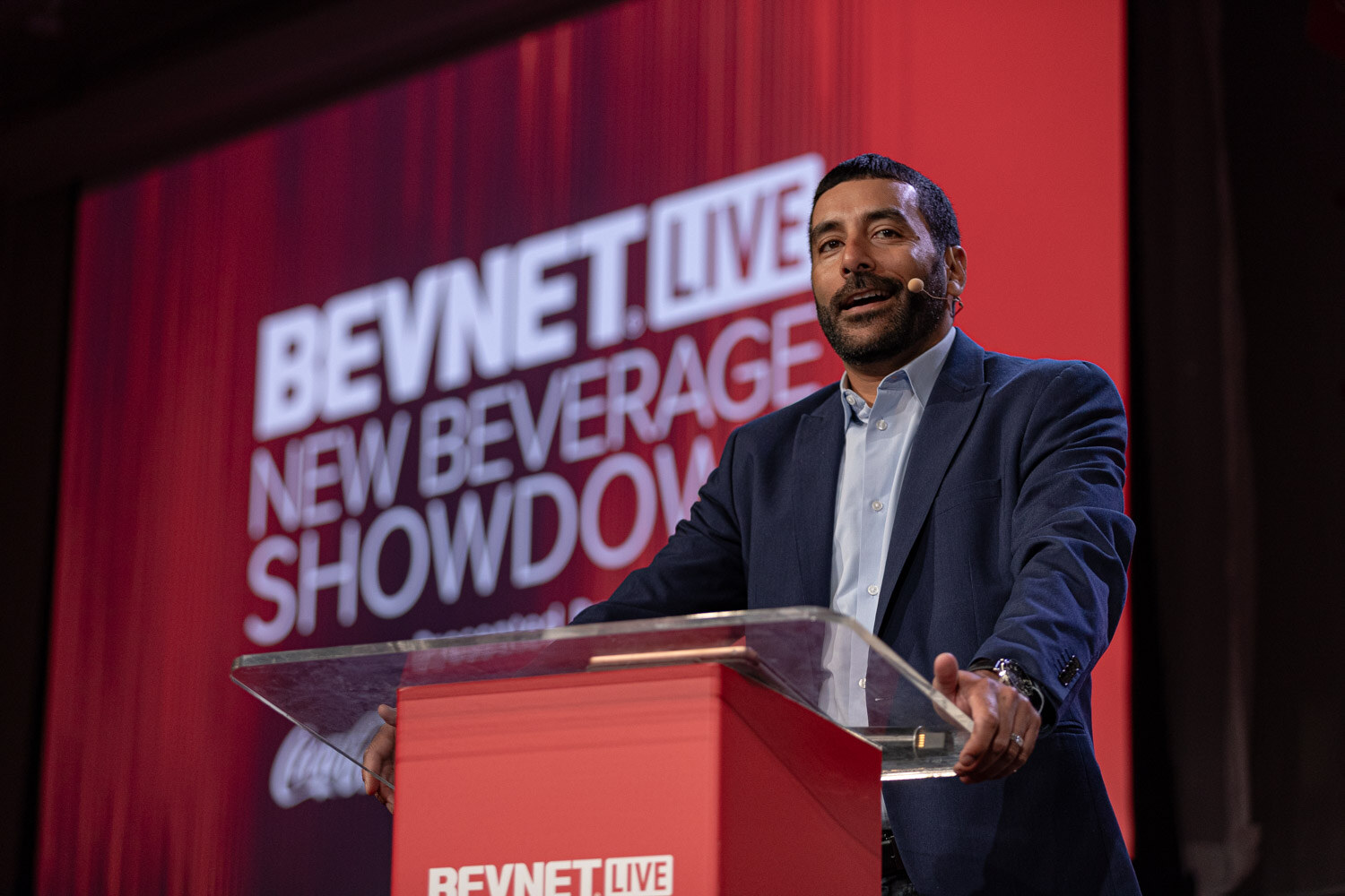 Emcee at the New Beverage Showdown podium introduces the finals judges.