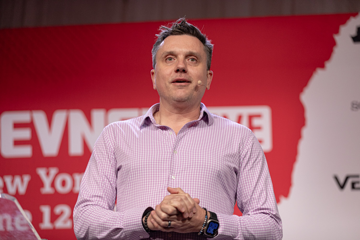 Host in a lavender checked shirt opens the BevNET Live general session.