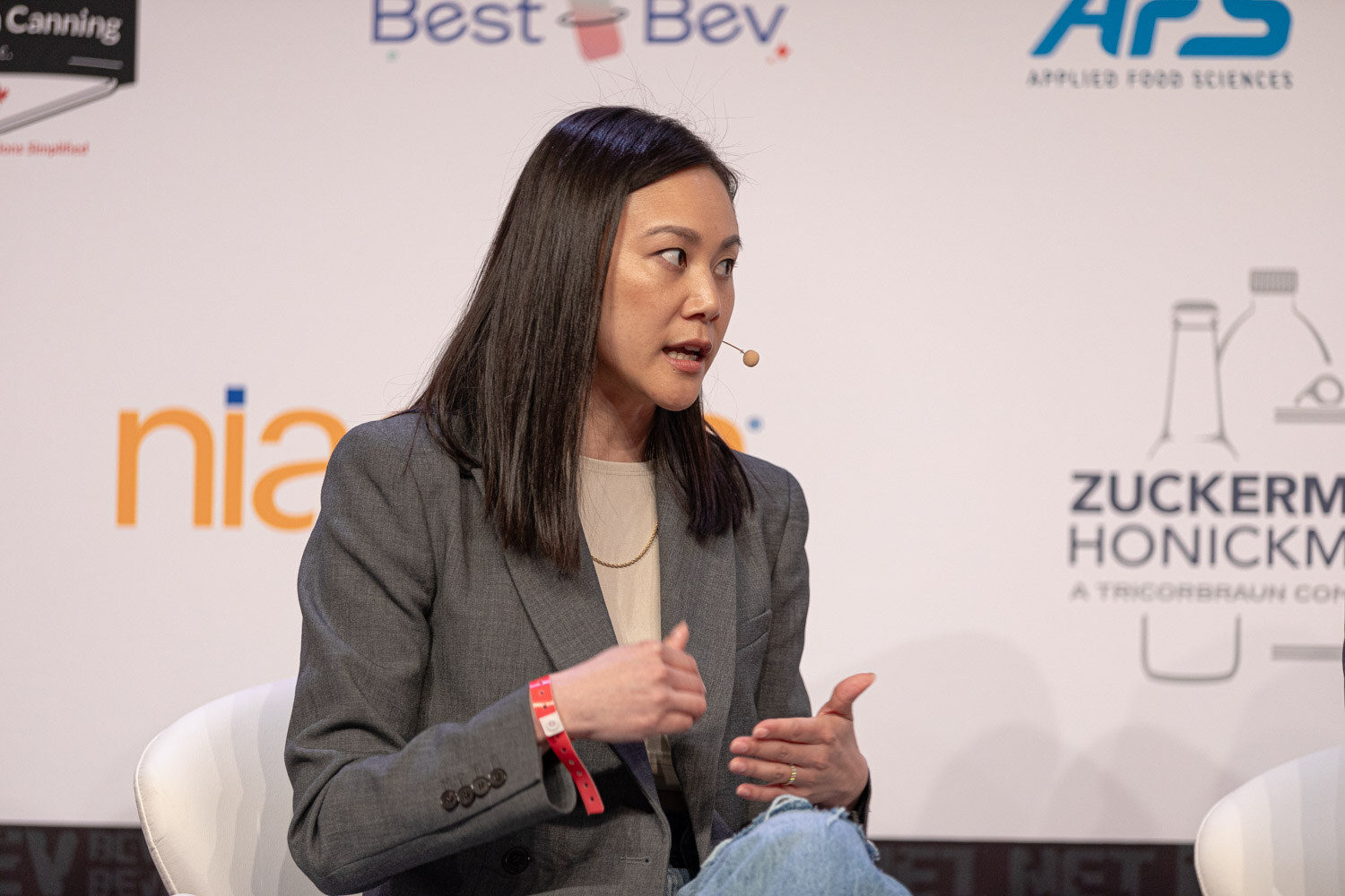 Panelist in a gray blazer speaks during the State of the Market session.