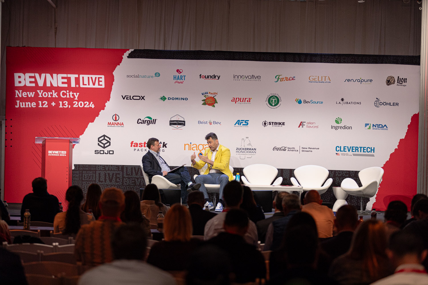 Wide view of the Tough Calls session on the main stage with the audience in front.