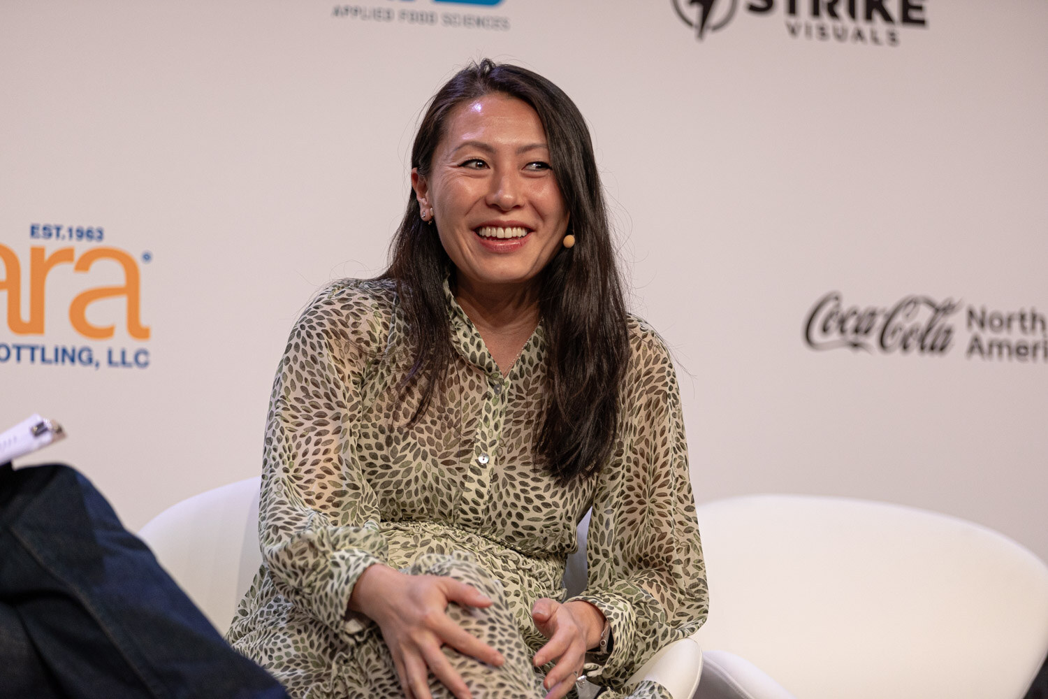 Guest in a patterned dress smiles during the Diageo Ventures session.