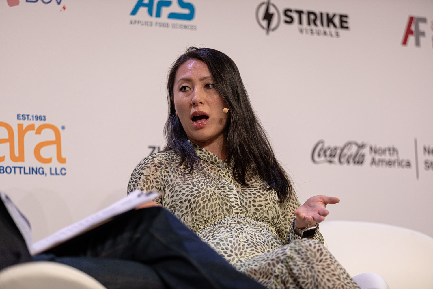 Guest in a patterned dress speaks with an animated expression during Diageo Ventures.