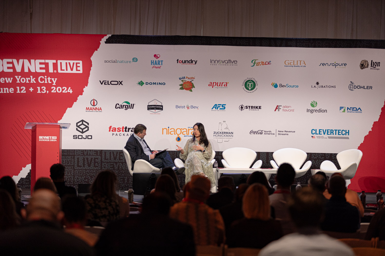 Wide view of the moderator and guest on the main stage during Diageo Ventures.