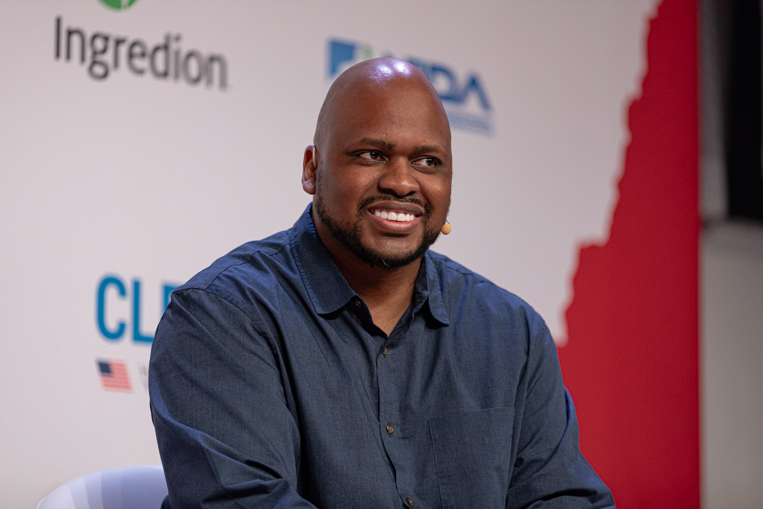 Panelist in a navy shirt smiles during Building the Category.