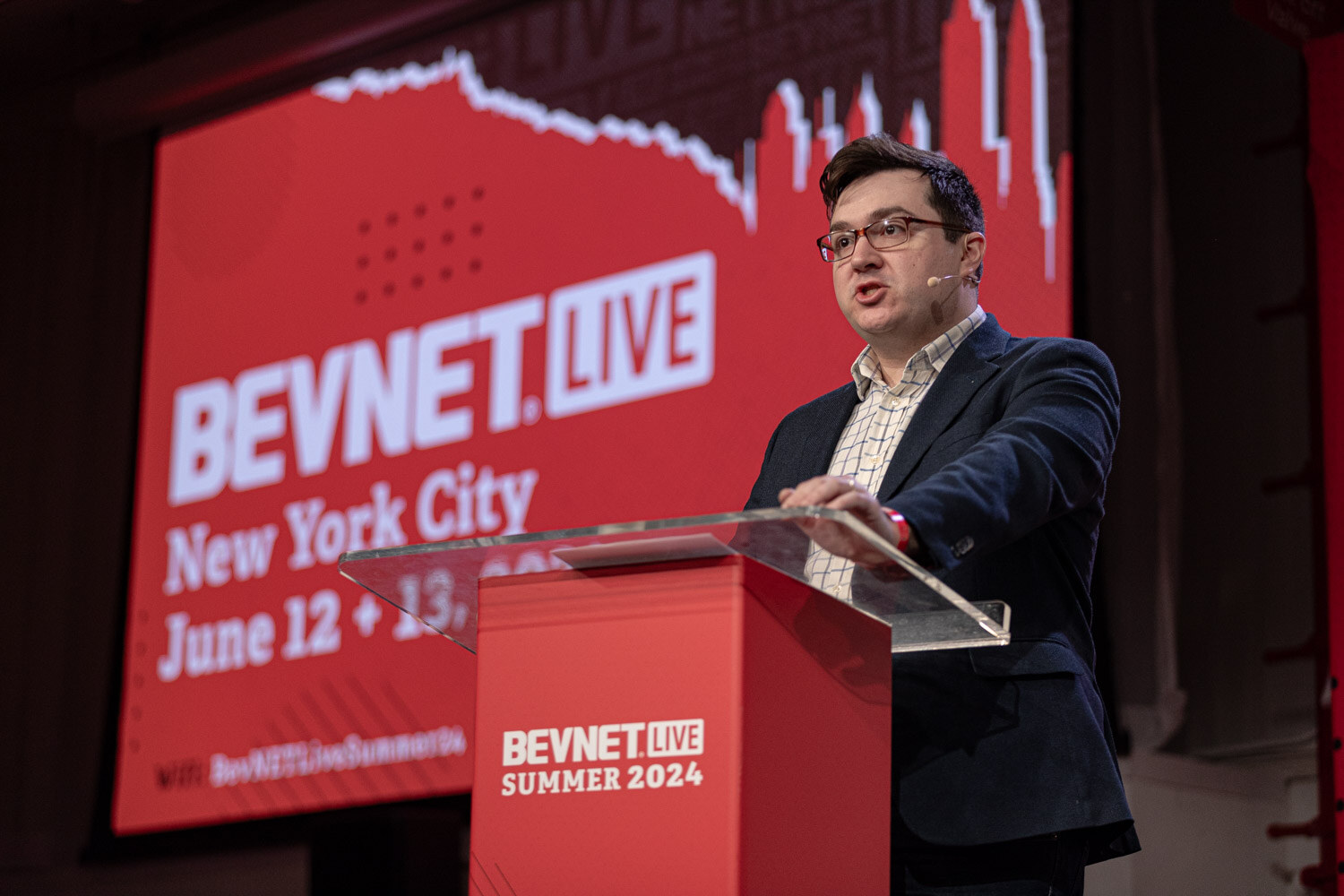 Moderator at the BevNET Live podium opens the Retailer Profile session.