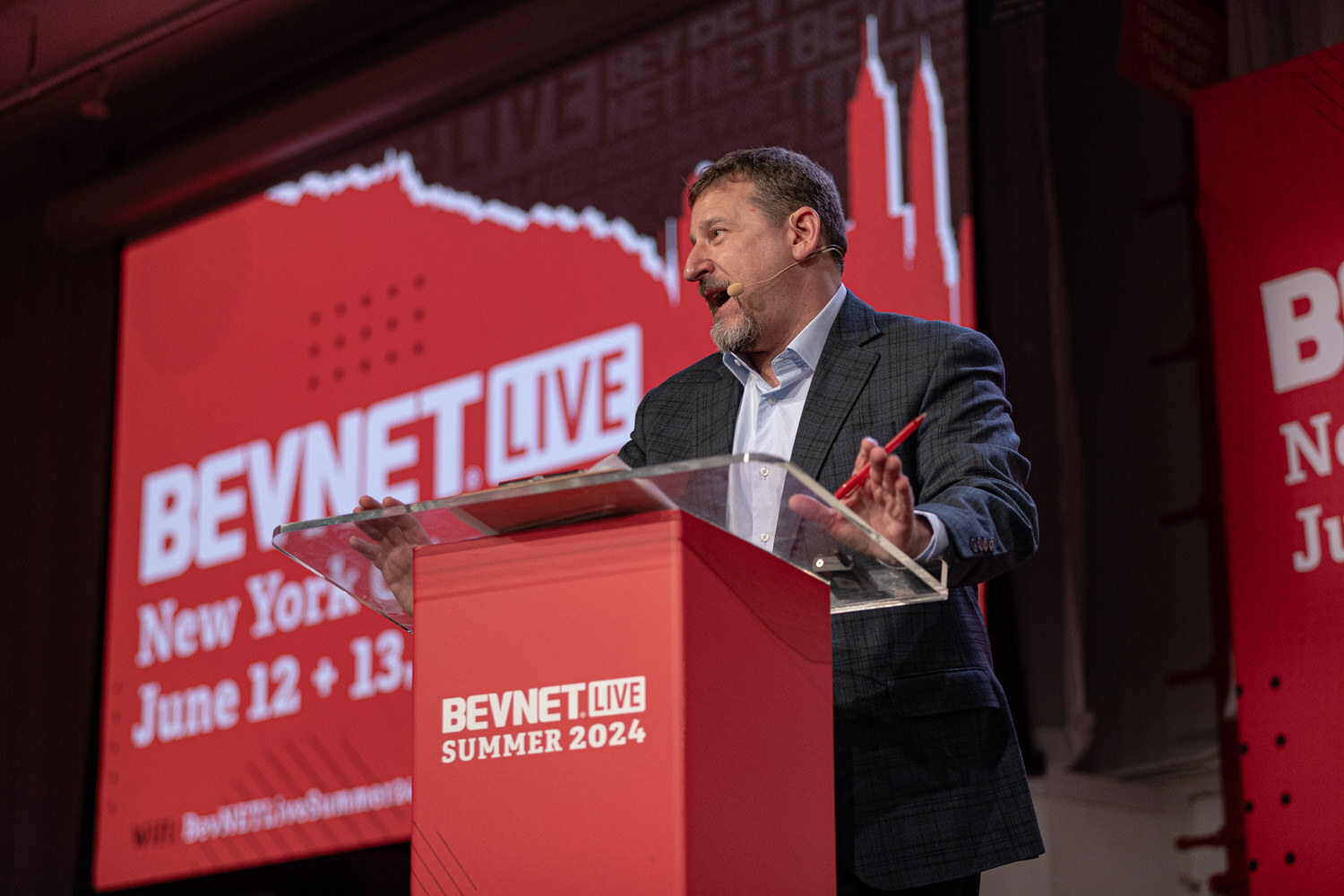 Moderator at the BevNET Live podium opens the Giant Steps session.