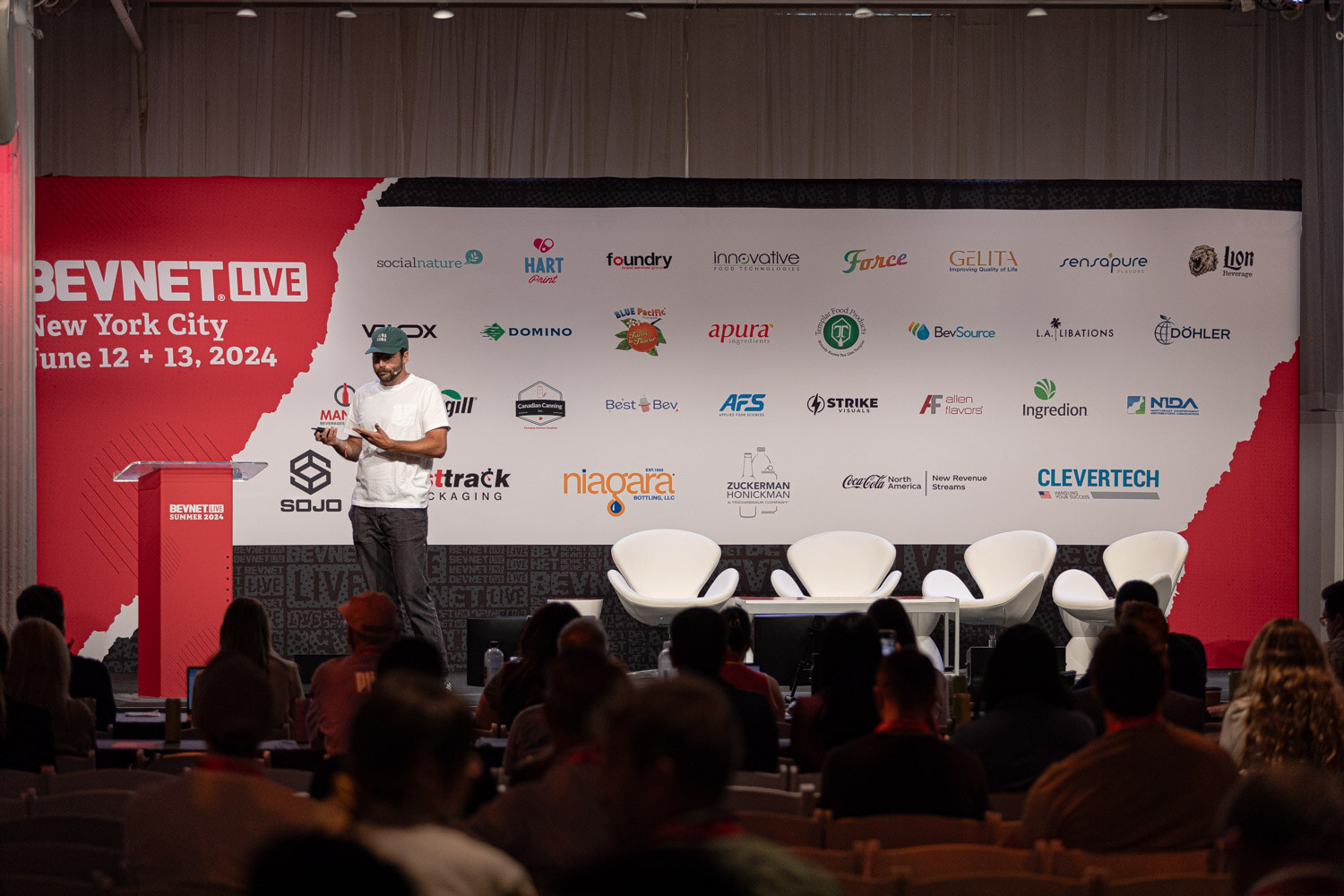 Wide view of the speaker on stage at the start of The Fundraising Journey.
