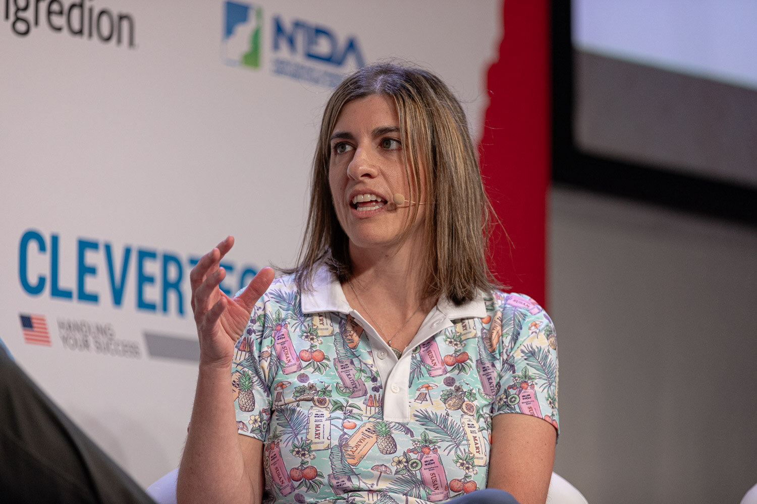 Panelist in a colorful patterned polo speaks during the Spirit World session.