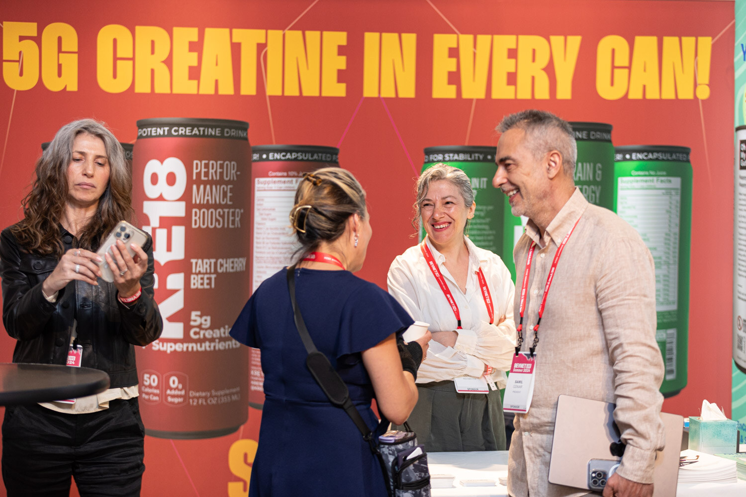 Attendees visit a K18 creatine drink booth on the BevNET Live exhibit floor.