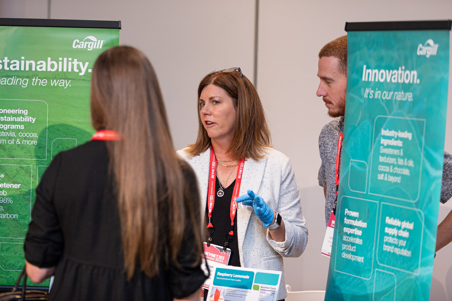 Representative speaks with an attendee at the Cargill sustainability and innovation booth.