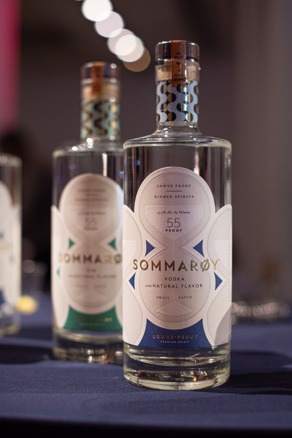 Sommaroy bottles on a navy tablecloth at the happy hour.