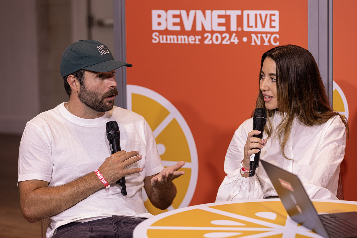 Two guests in white shirts talk at the Taste Radio livestream set.