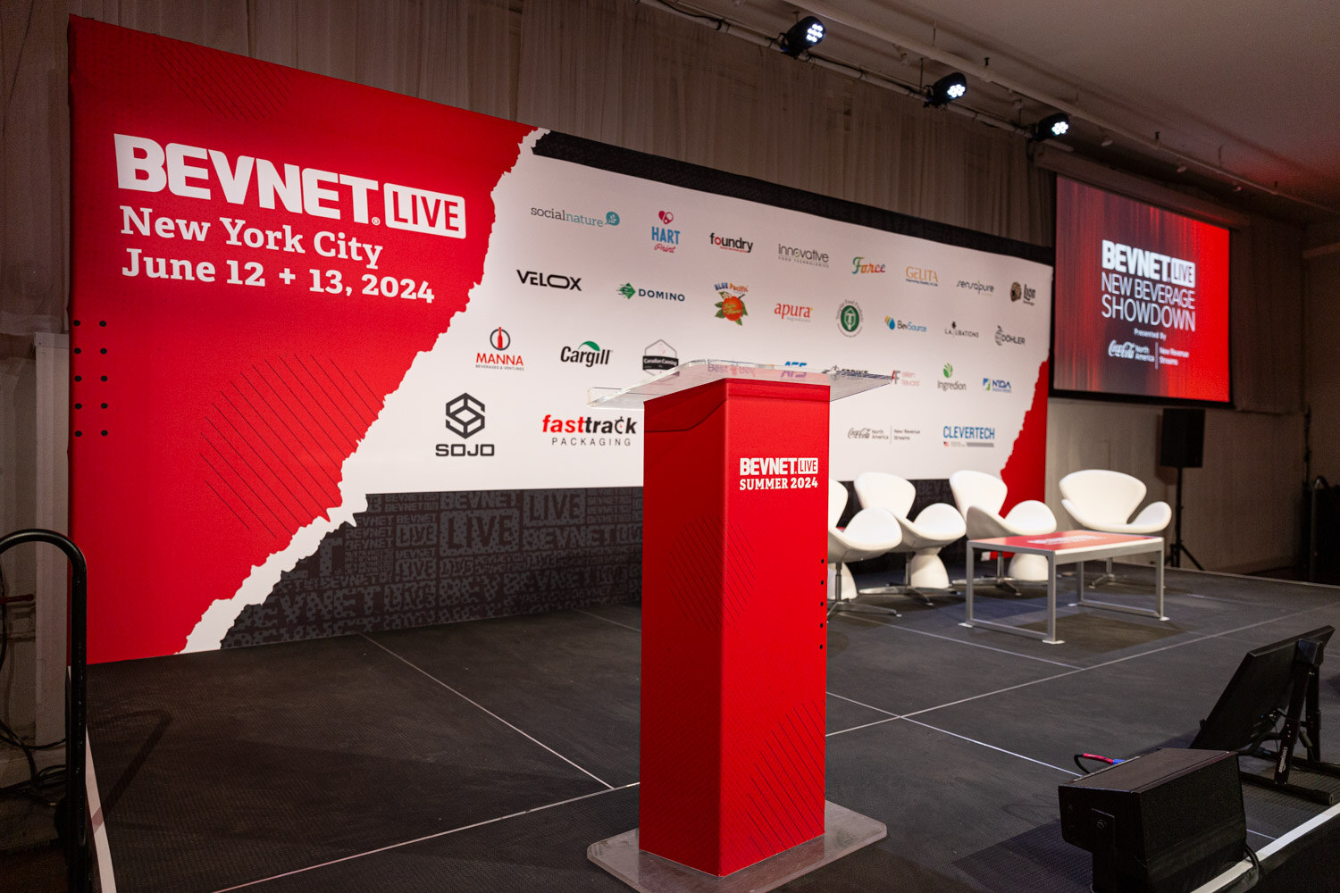 Main stage podium and sponsor wall before the sessions.