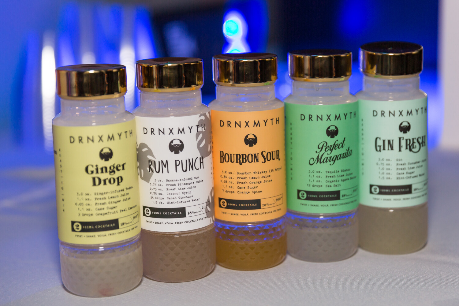 Five bottles labeled with flavors like Ginger Drop and Rum Punch.