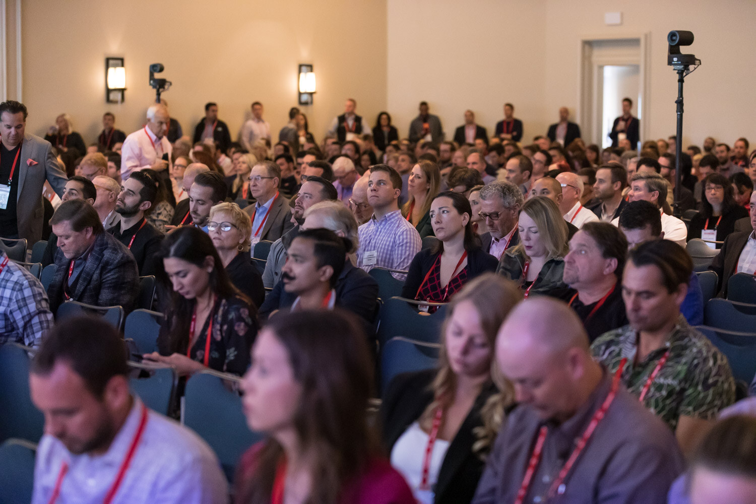 Rows of seated conference attendees looking toward the stage.