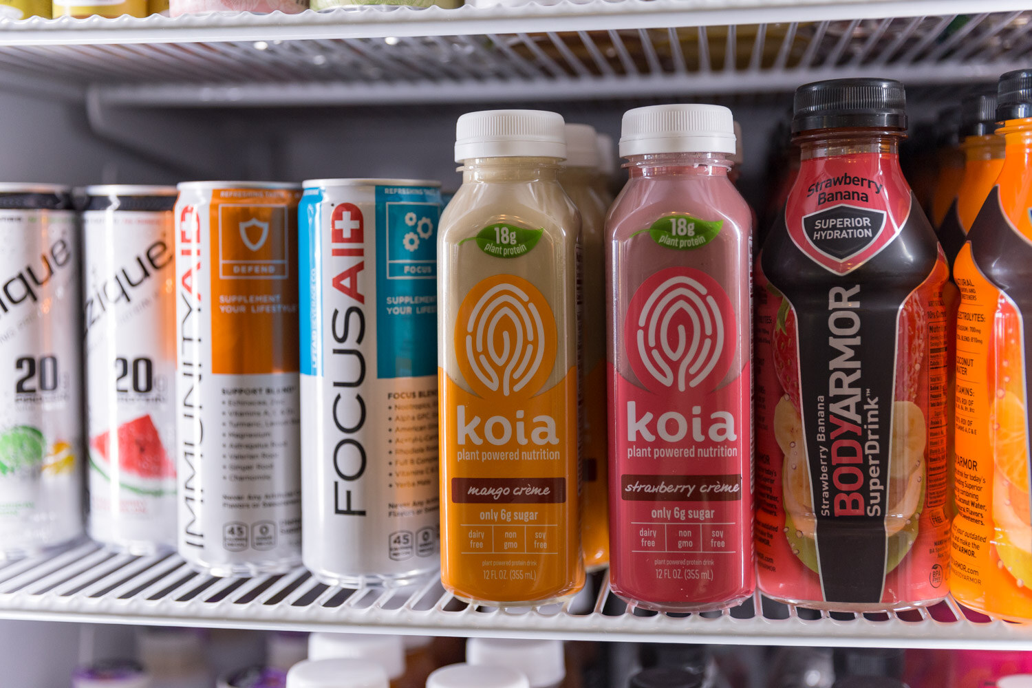 Shelf of bottled drinks including Koia, Focus Aid and BodyArmor.