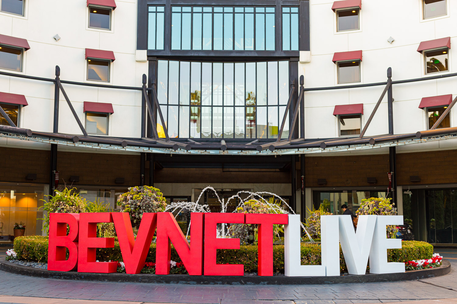Giant BevNET LIVE letters stand in a planter in front of the hotel's entrance and fountain.