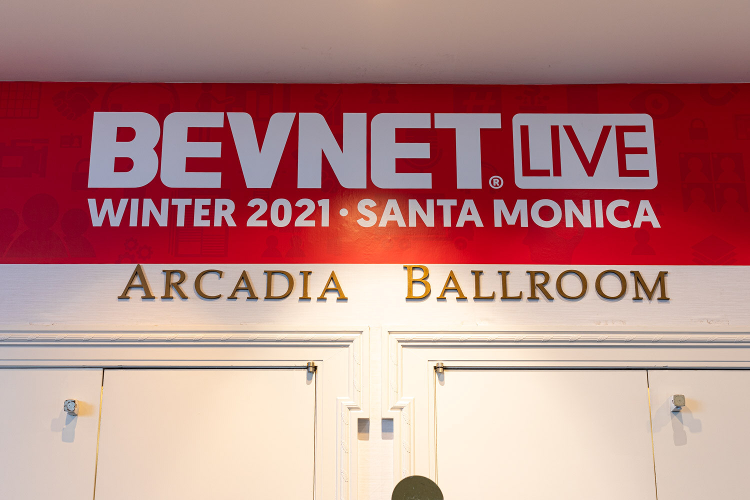 A red banner reading BevNET Live Winter 2021 Santa Monica above gold lettering Arcadia Ballroom over double doors.