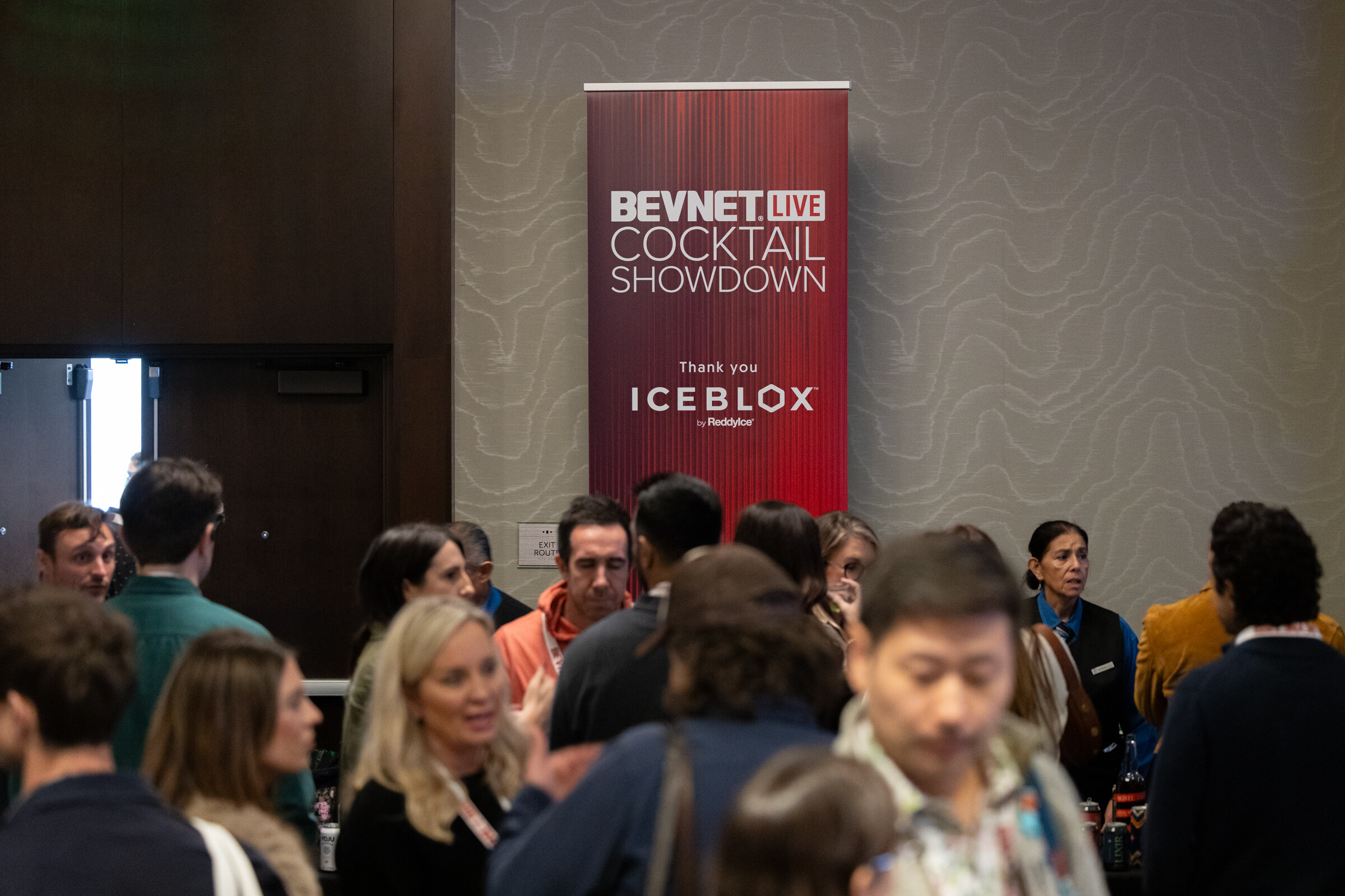 Crowd of attendees in front of a red BevNET Live Cocktail Showdown Thank you Iceblox banner.