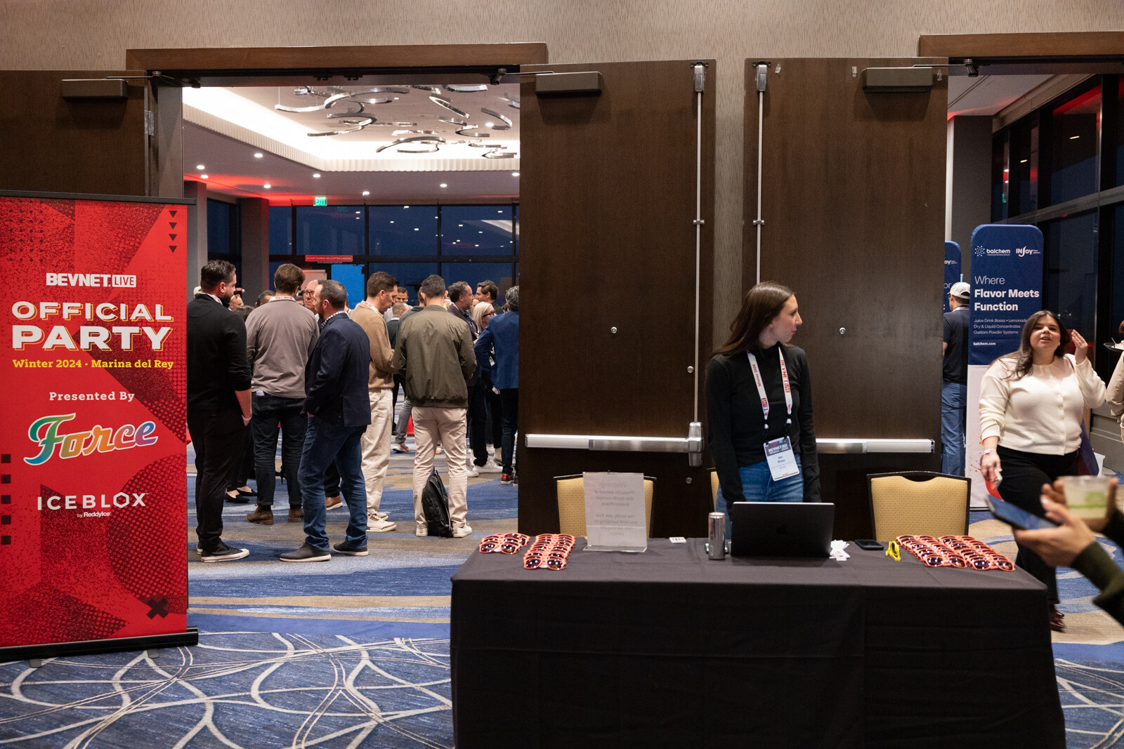 People gather in a ballroom around a BevNET Live Official Party banner presented by Force with a registration table.