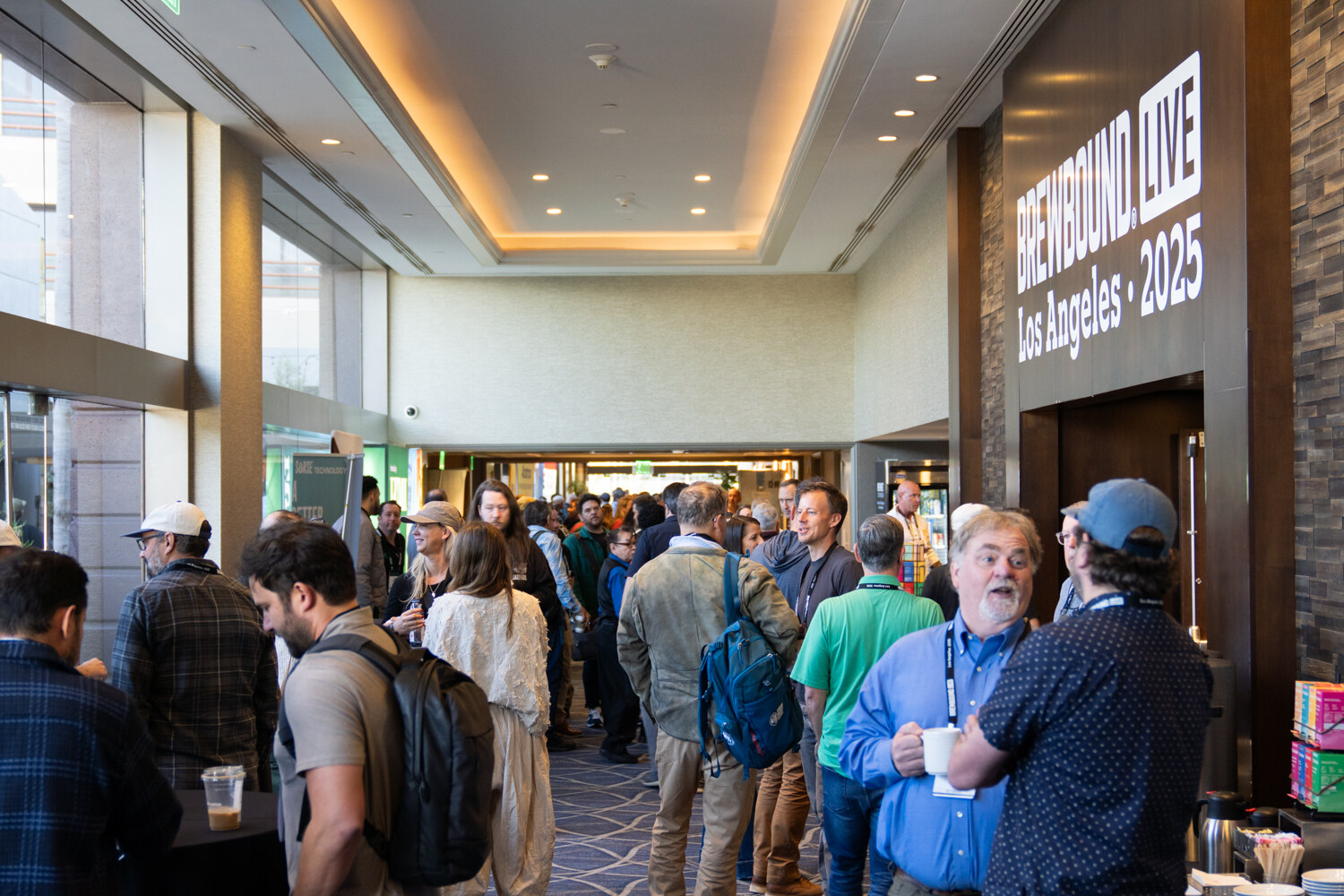 Crowded hallway under a Brewbound Live Los Angeles 2025 sign, with attendees talking and holding coffee cups.