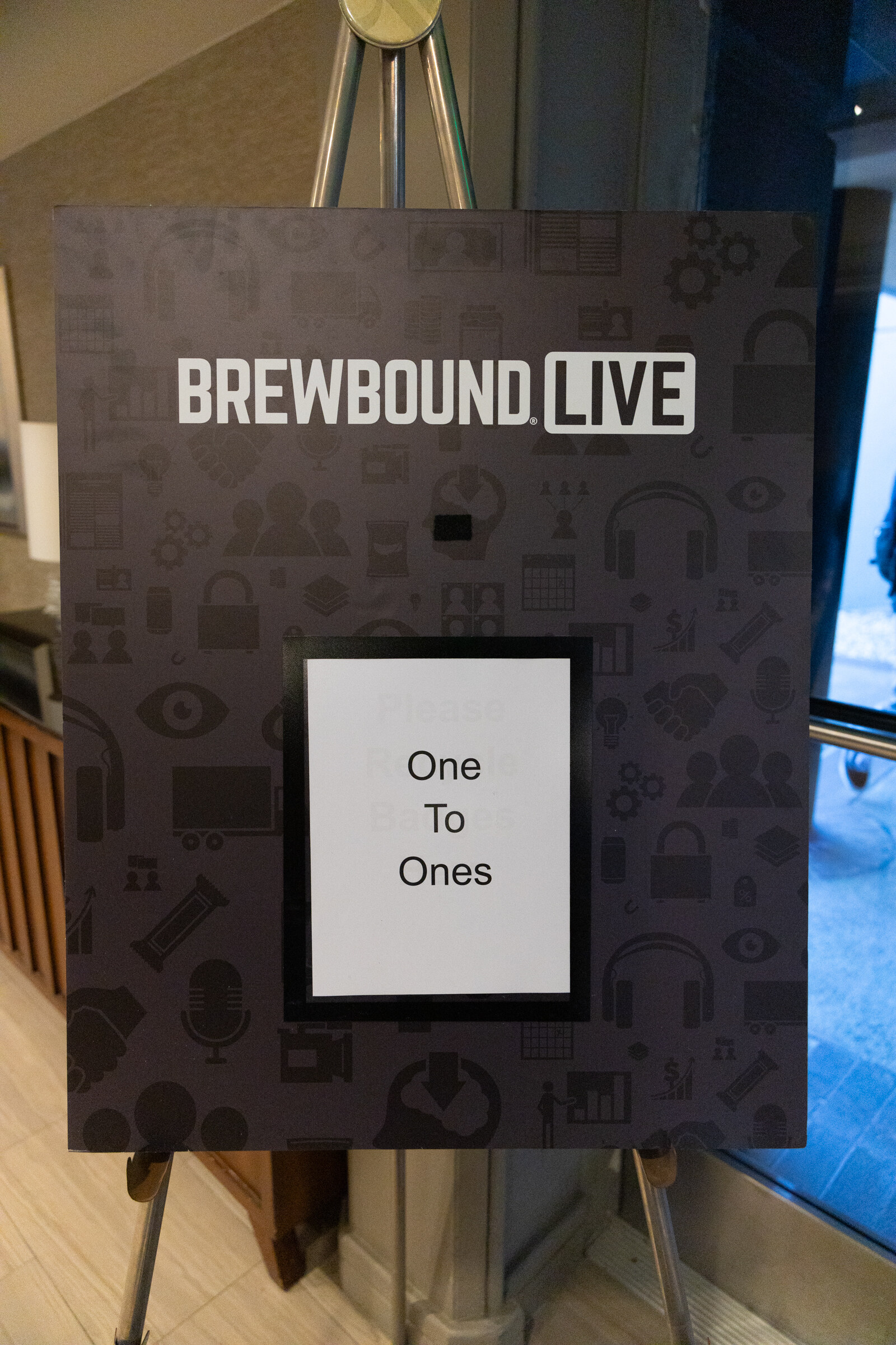 Black Brewbound Live easel sign with a card reading One To Ones.