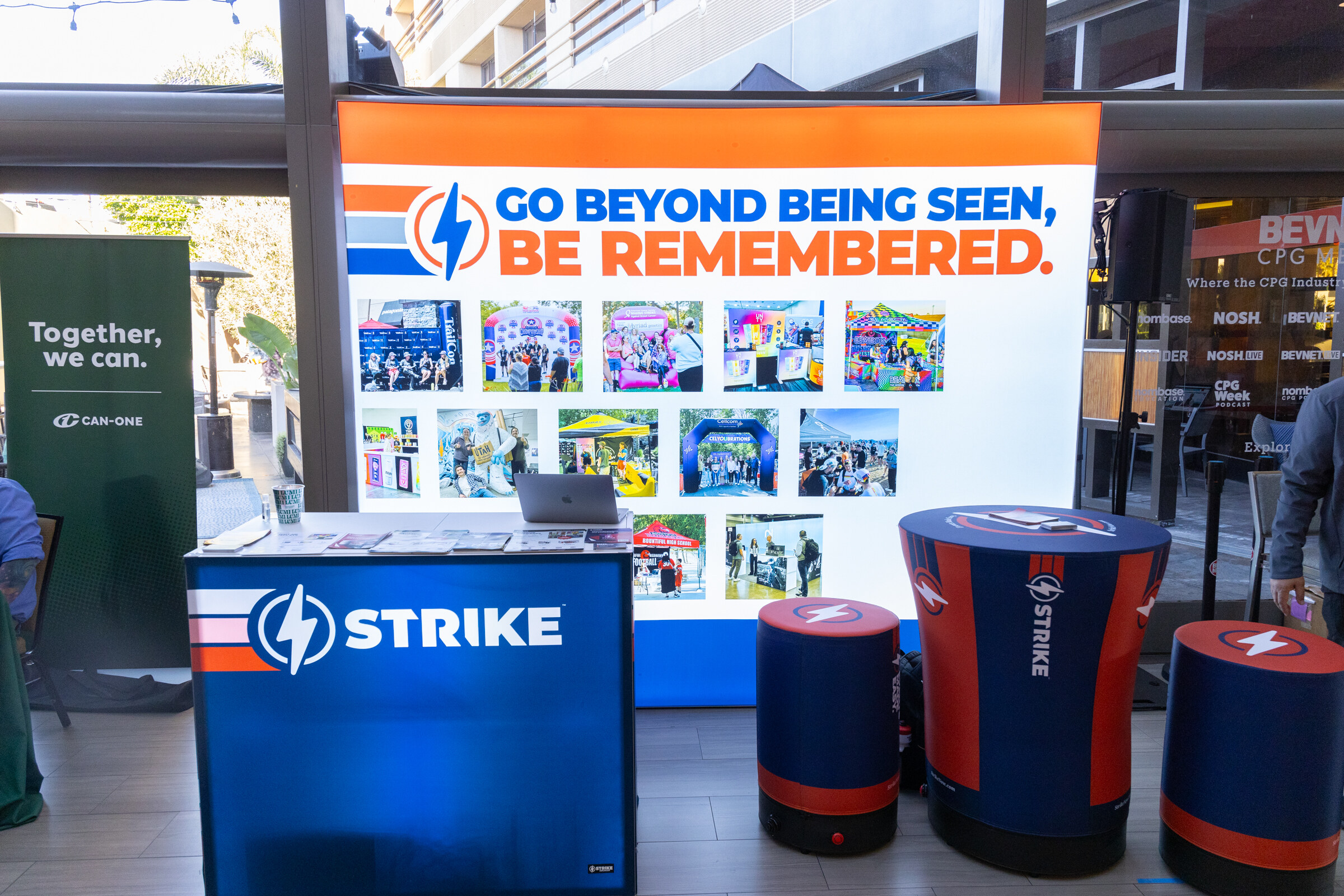 Blue Strike counter and stools in front of a banner reading Go beyond being seen, be remembered.