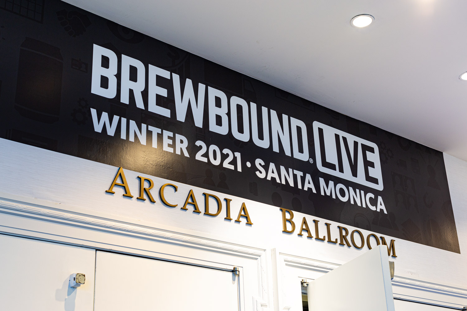 A black sign reading Brewbound Live Winter 2021 Santa Monica above gold letters spelling Arcadia Ballroom.