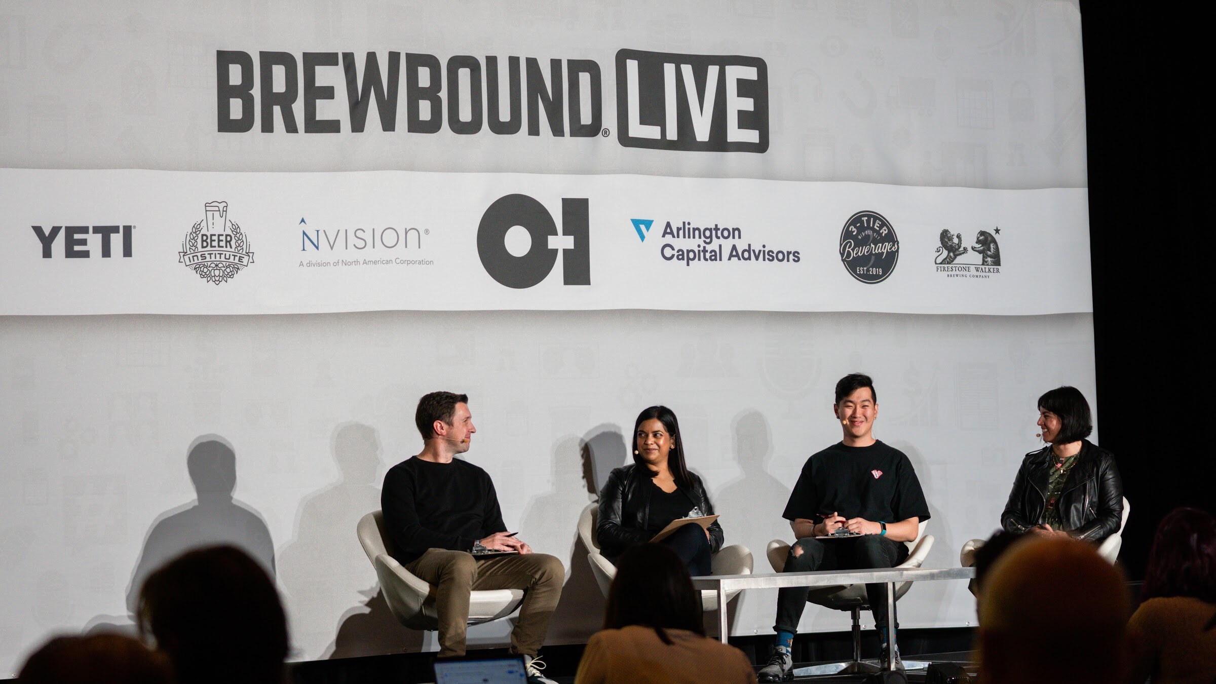 Four judges sit in white chairs in front of a Brewbound Live backdrop with sponsor logos including YETI, O-I and Arlington Capital Advisors.