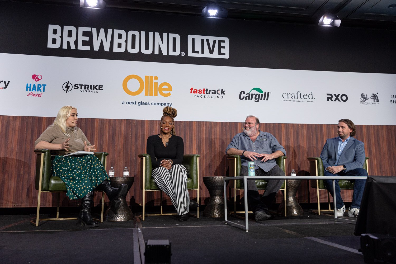 Four people sit in green armchairs on stage under the Brewbound Live banner and sponsor logos.