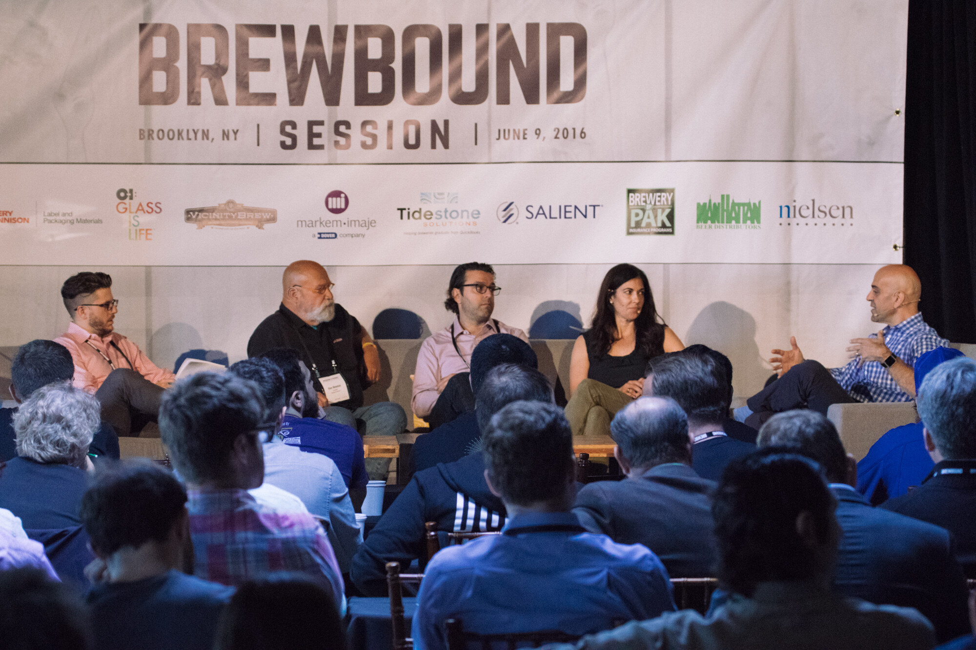 Five people on a stage couch set under a Brewbound Session Brooklyn June 9, 2016 banner, with audience members seen from behind.