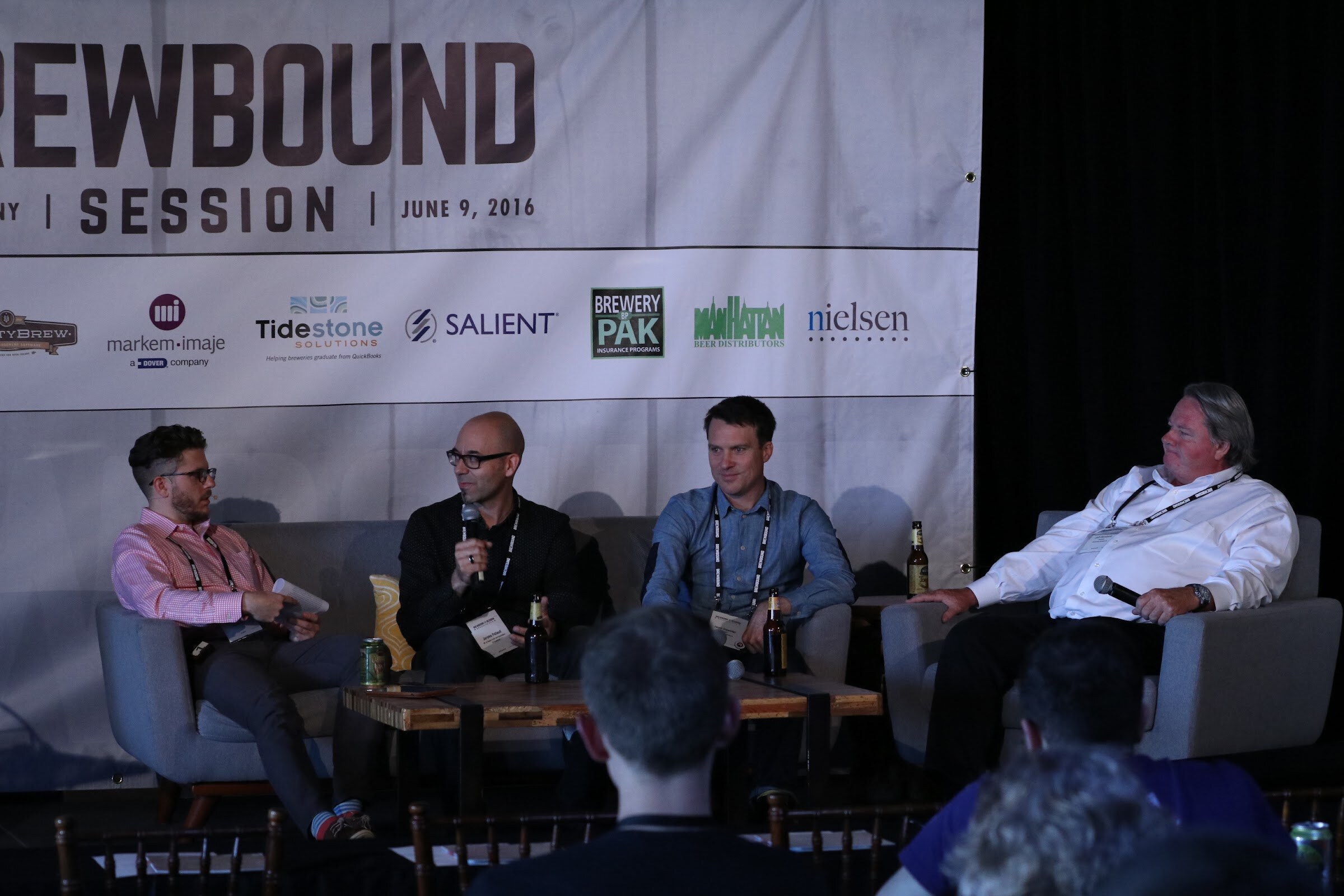 Four men seated on stage couches and chairs under a Brewbound Session banner dated June 9, 2016, with audience heads in the foreground.