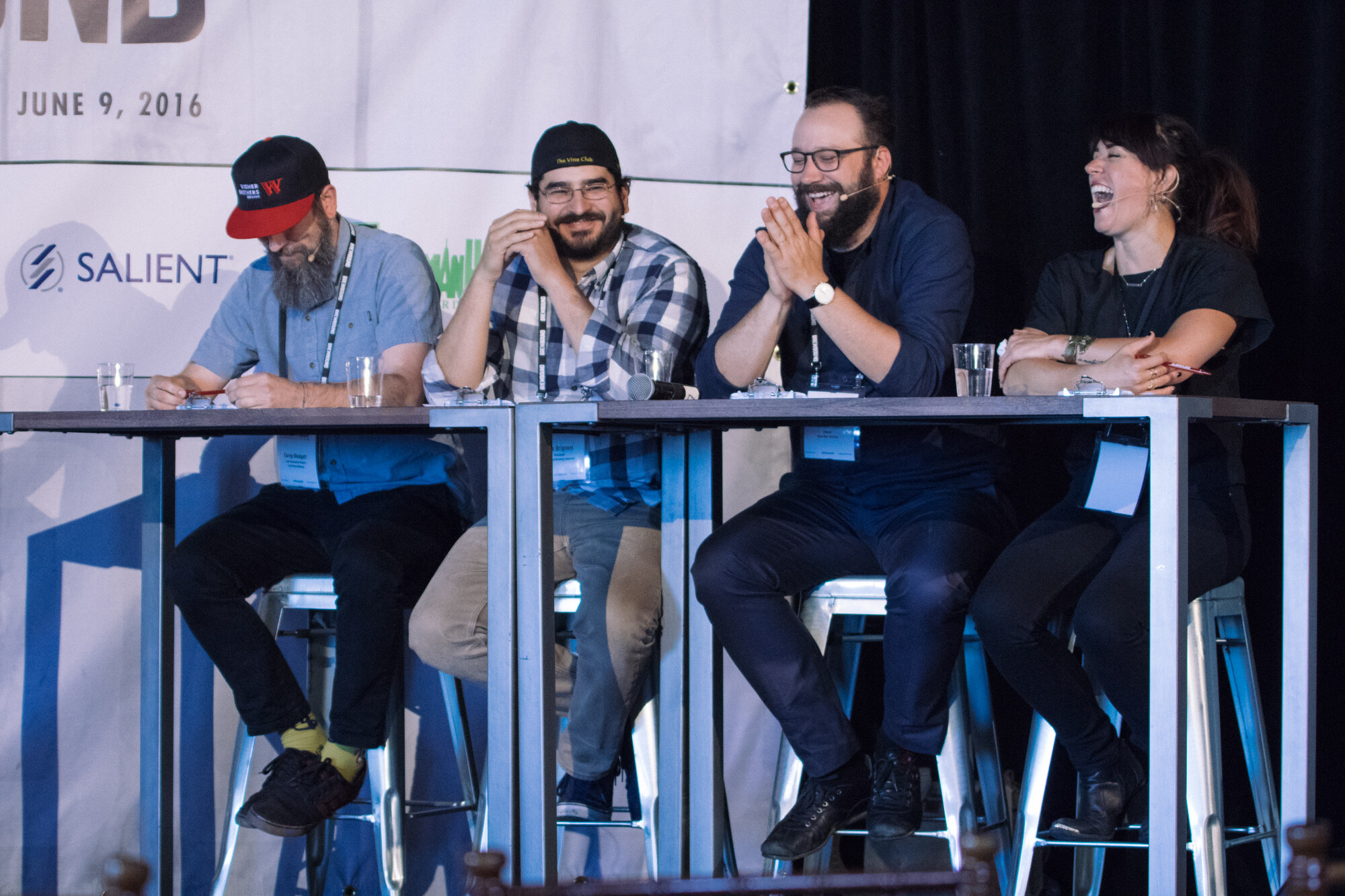 Four people on stools at high tables on stage, laughing, with a Brewbound Session banner dated June 9, 2016 behind them.
