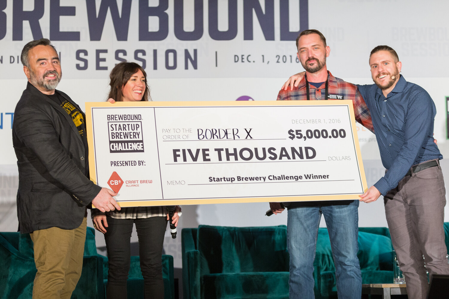 Four people on stage smiling and holding a large check that reads Border X, Five Thousand, $5,000.00, Startup Brewery Challenge Winner, with the Brewbound Session banner dated Dec. 1, 2016 above.
