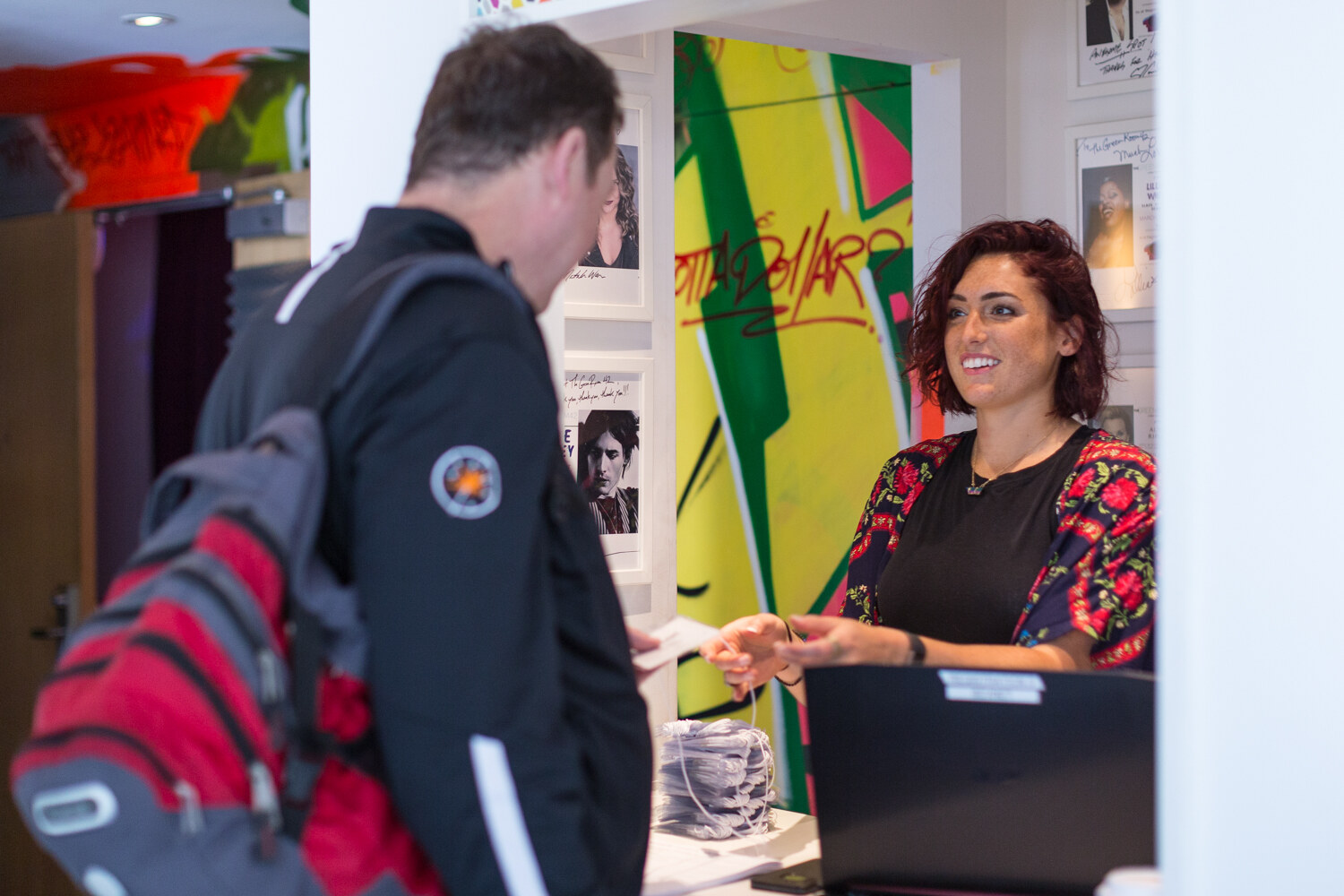 A registration staffer greets an arriving attendee at the Boot Camp check-in desk.