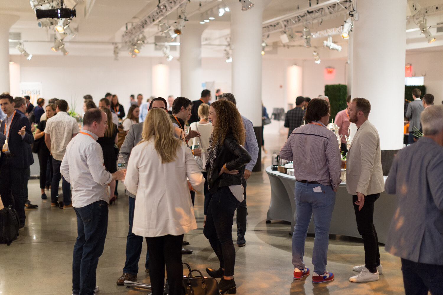 Attendees mingle in the open event space at the networking break.