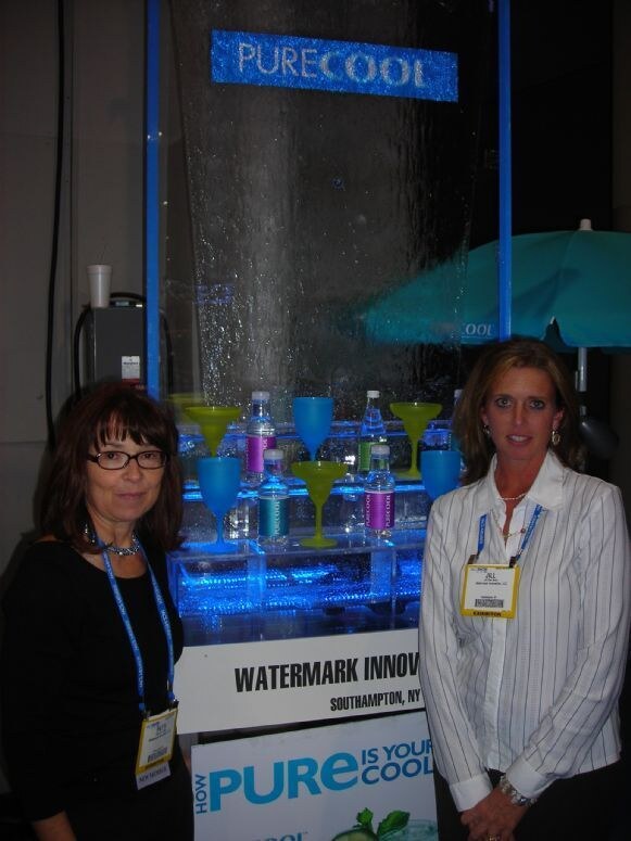 Patti and Jill of PureCool at the PureCool display at the NACS 2007 trade show. The photo is unavailable, so this description is based on the listed people, brand and event.