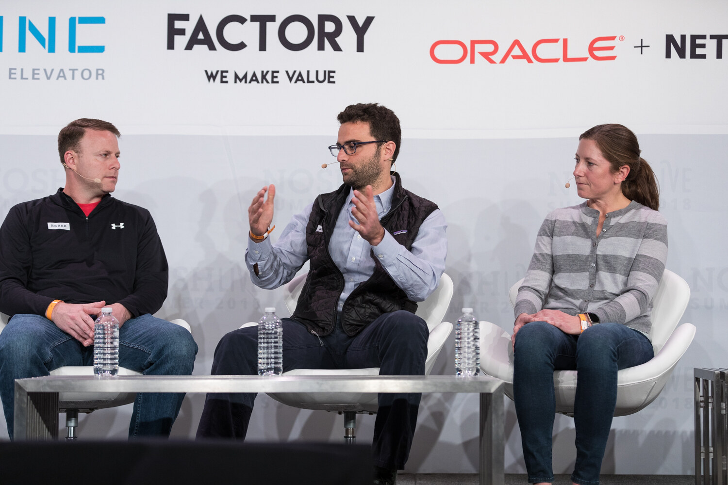 Three panelists seated side by side in front of 301 Inc, Factory and Oracle NetSuite banners during the Big Deal session.