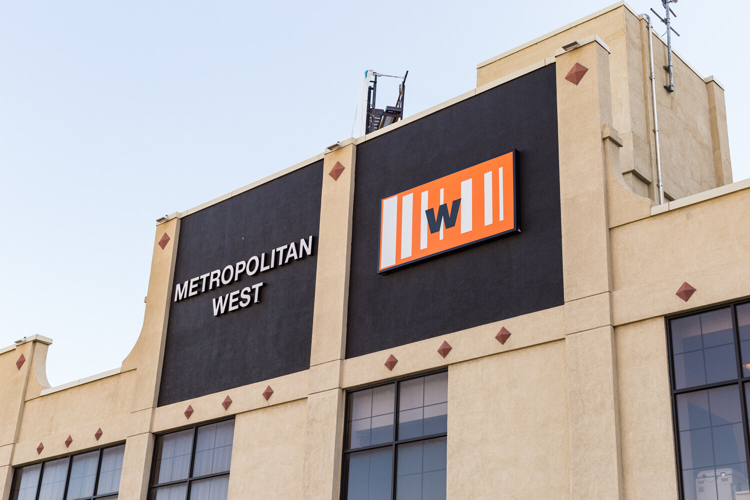 The exterior of the Metropolitan West building with its orange W sign.